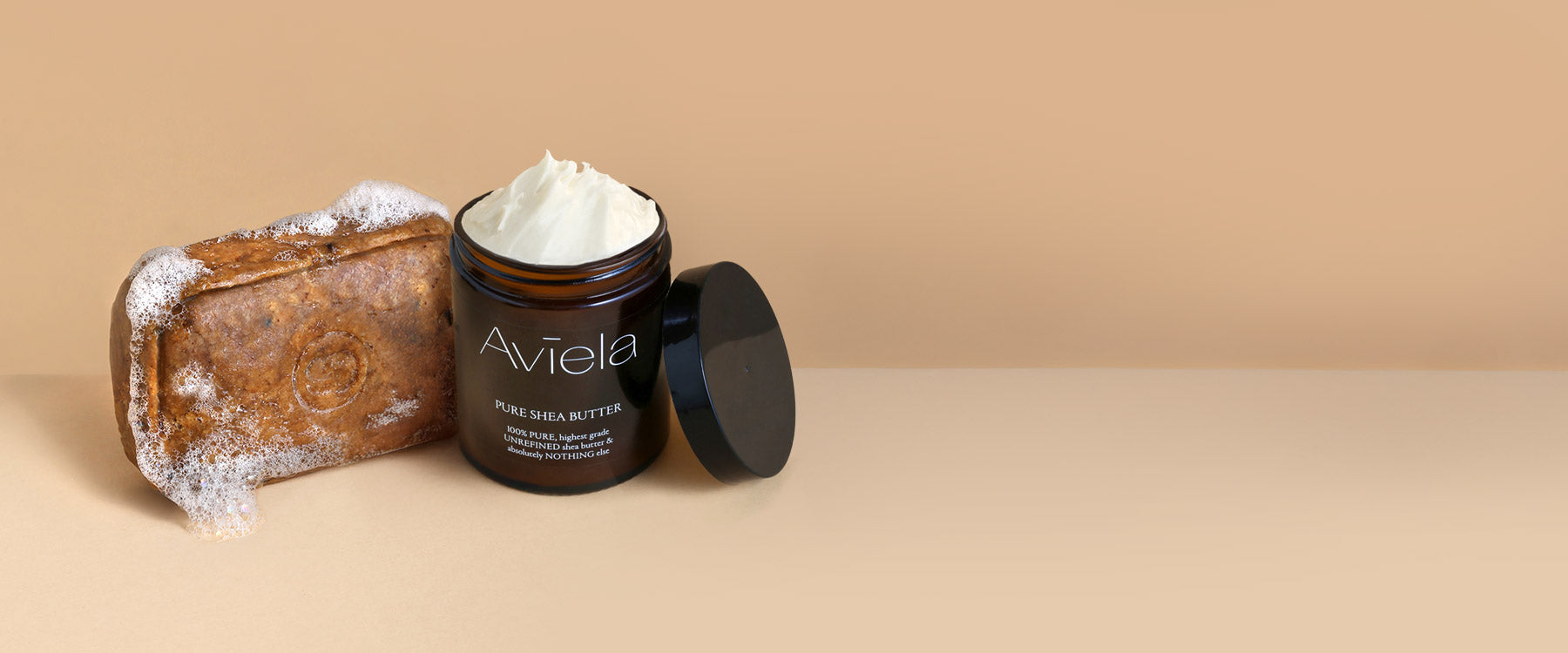 Aviela Pure Shea Butter jar and a natural African Black Soap bar shown together in a clean studio setting.