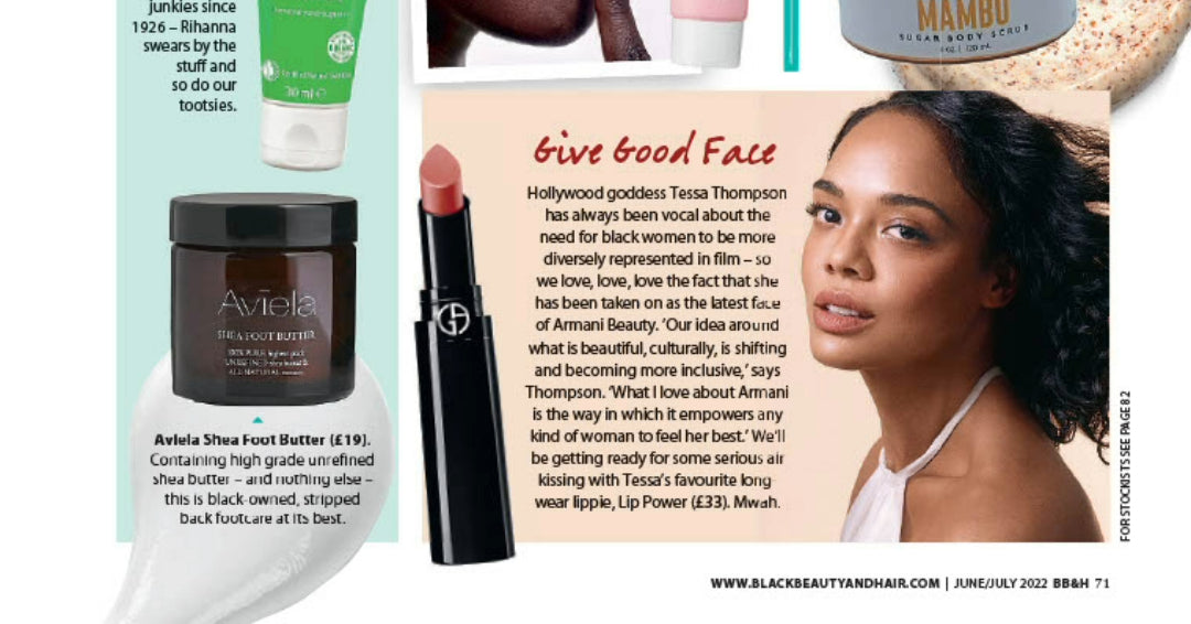 A cropped magazine feature showing an Aviela Shea Foot Butter jar. The jar is a dark, translucent brown with a black lid. The label reads "Aviela SHEA FOOT BUTTER" with additional text below. The jar is placed on a white, abstract shape. Below the jar, text describes the product as a black-owned brand containing high-grade unrefined shea butter.